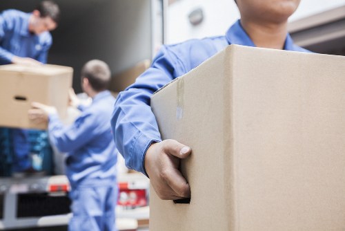 Professional movers loading packed household items in Merton
