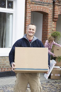 Removal team planning a local move in Merton with packing boxes
