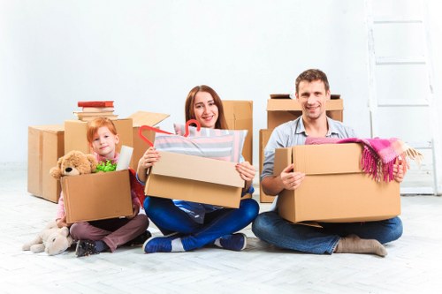 Movers team carefully loading furniture with safety equipment