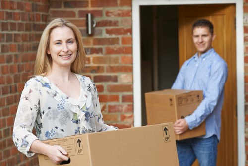 Packed boxes and furniture prepared for same day removals in a Merton flat