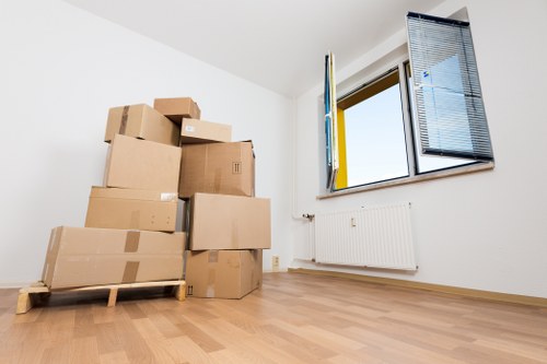 Same day removals crew handling furniture and boxes at a Merton property