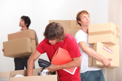 Office team preparing desks, documents, and IT equipment for a move in Merton