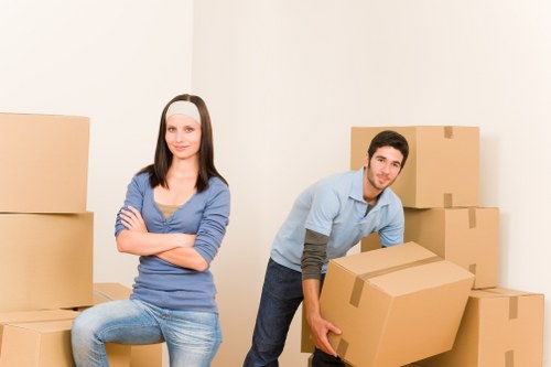 Local movers handling furniture and boxes during a Merton move